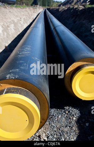 Underground district heating pipeline under construction.Part of the pipes already dug into ground , Finland Stock Photo