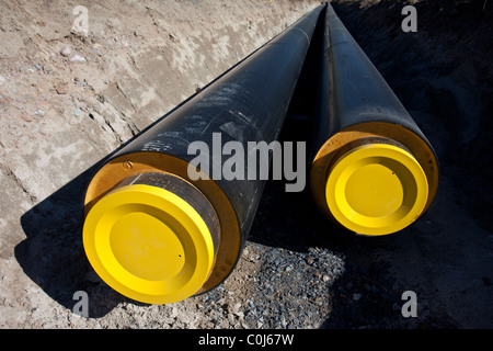 Underground district heating pipeline under construction.Part of the pipes already dug into ground , Finland Stock Photo