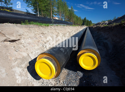 Underground district heating pipeline under construction.Some of the pipes already dug into ground , Finland Stock Photo