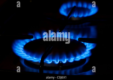 Blue gas flame of on oven in the dark Stock Photo