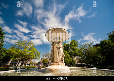 Washington DC, the white marble fountain in Dupont Circle. The statue symbolizes The Sea and is carrying a ship. In spring. Stock Photo
