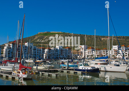 Boats moored at Marina port area with Kasbah in background Agadir the Souss southern Morocco Africa Stock Photo