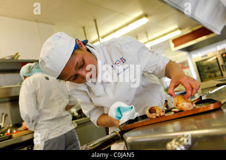 Chefs in a kitchen preparing food at a college for further and higher education Stock Photo