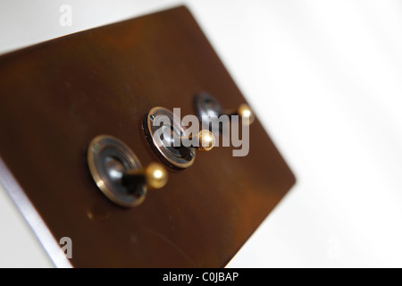Traditional light switch in a room on a white wall Stock Photo