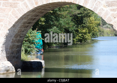 view of Canal du Midi through a little stoned bridge, near Carcassonne, France Stock Photo