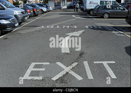 Exit sign and direction arrow pointing way out at car park in East Grinstead UK Stock Photo