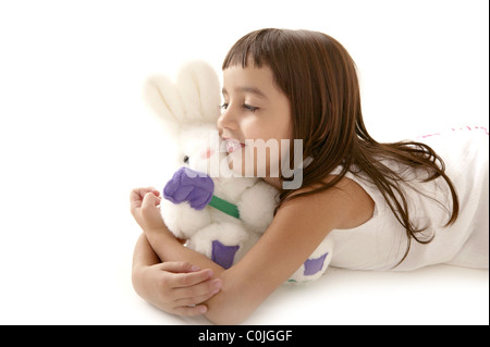 beautiful little mexican girl playing with toy Stock Photo