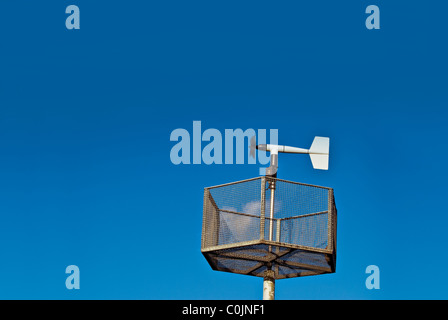 An Anemometer measuring wind speed set against a blue sky. Stock Photo