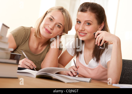 Two students studying home and having coffee Stock Photo