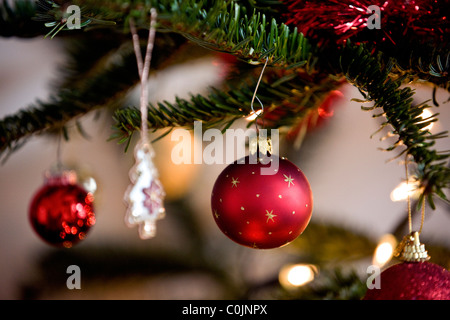 A red bauble hanging on a Christmas tree Stock Photo