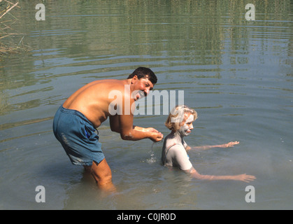 Tourists in Turkey enjoying the mud in the thermal springs near Dalyan.  There are baths at Sultaniye but many like the natural. Stock Photo