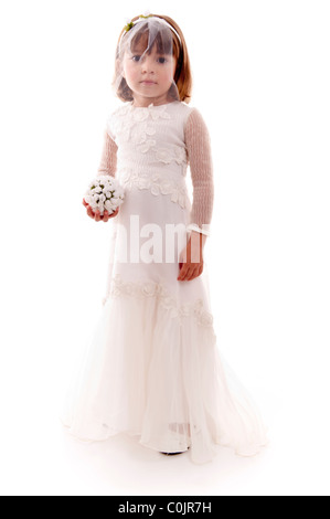 Beautiful child with bride clothes holding a bouquet . Stock Photo