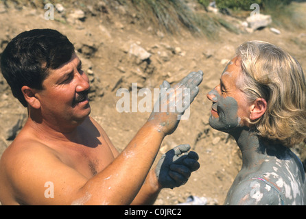 Tourists in Turkey enjoying the mud in the thermal springs near Dalyan.  There are baths at Sultaniye but many like the natural. Stock Photo