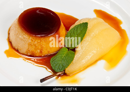 Chef's Presentation dishes - Ginger crème caramel; poached pear. Stock Photo