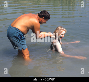 Tourists in Turkey enjoying the mud in the thermal springs near Dalyan.  There are baths at Sultaniye but many like the natural. Stock Photo