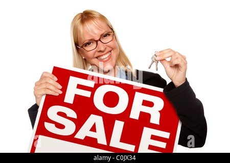 Attractive Blonde Holding Keys & For Sale Sign Isolated on a White Background. Stock Photo