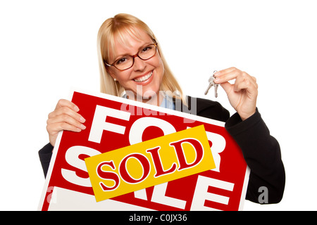 Attractive Blonde Holding Keys & Sold For Sale Sign Isolated on a White Background. Stock Photo