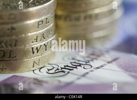 Twenty pound sterling notes and one pound coins are set up for a photograph Stock Photo