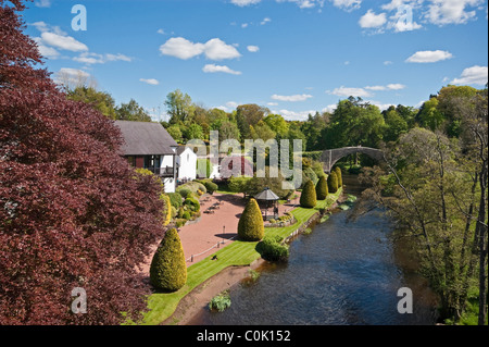 Medieval Brig O’Doon at the Burns National Heritage Park in Alloway Scotland spanning the River Doon in the background. Stock Photo