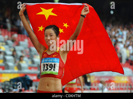 Zhou Chunxiu of China celebrates after winning bronze after the women's marathon at the Beijing 2008 Olympic Games in the Stock Photo