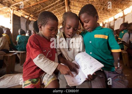 Children learn in a grass hut school in Dedza, Malawi, Southern Africa. Stock Photo
