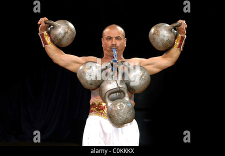 The Moscow State Circus Pictured strong man Bakhrom Akhnazarov Stock Photo