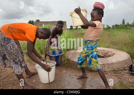 Girls fetch water from a village well in Safo, Mali, West Africa. Stock Photo