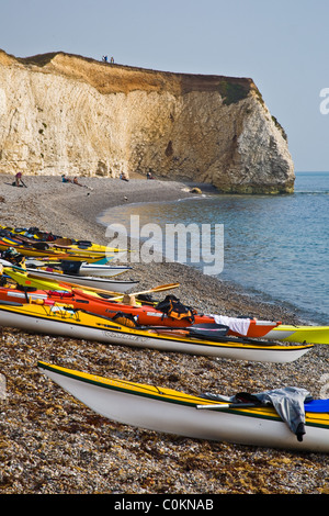 Kayaks pulled up on the pebble beach of Freshwater Bay Stock Photo