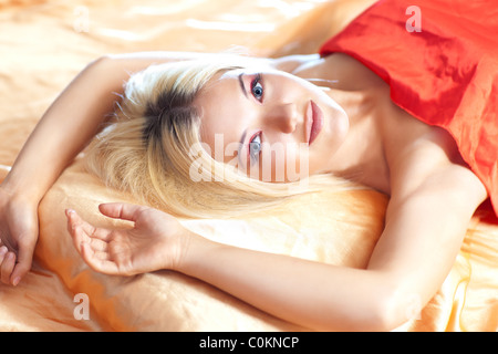 Young woman in bed early sunny morning.