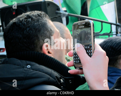 Paris, France, Libya Demonstration, in Support of Libyan Revolution, Detail Hands Man from Behind, holding Smart Phone, Taking Photos, france mobile phones Stock Photo