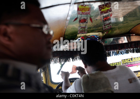 A street view in a Jeepney. Jeepneys are the most popular means of public transport in the Philippines. Stock Photo