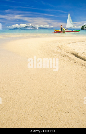 Outrigger canoes on white sand beach in the south pacific. Huahine, French Polynesia Stock Photo