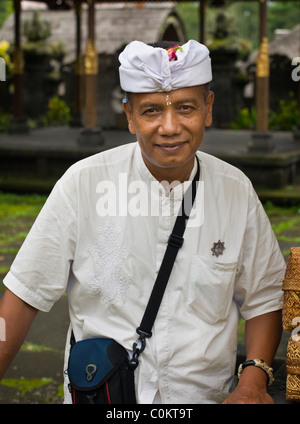 A Balinese man in traditional dress attends a Hindu full moon ceremony at the most holy of Bali temples, Besakih. Stock Photo