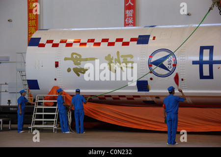 LAUNCH ROCKET IS READY FOR LIFT-OFF Scientists make last-minute checks to a rocket prior to the launch of China's historic Stock Photo