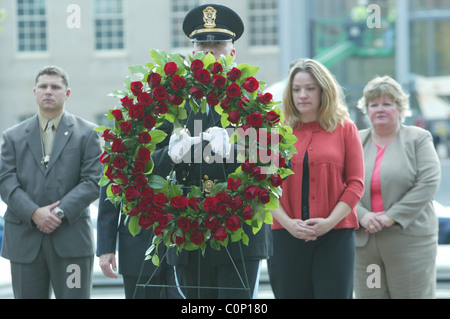 The bereaved hold their rose before placing on the National Law Enforcement Officers Memorial at the 17th Annual Wreath laying Stock Photo