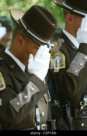 The bereaved hold their rose before placing on the National Law Enforcement Officers Memorial at the 17th Annual Wreath laying Stock Photo