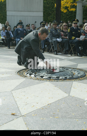 The bereaved hold their rose before placing on the National Law Enforcement Officers Memorial at the 17th Annual Wreath laying Stock Photo