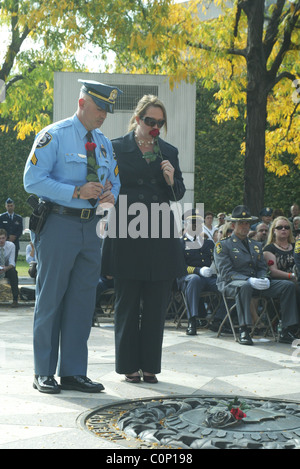 The bereaved hold their rose before placing on the National Law Enforcement Officers Memorial at the 17th Annual Wreath laying Stock Photo