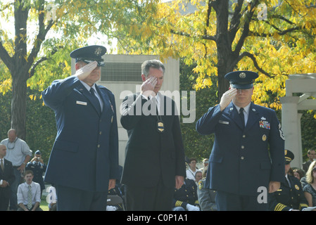 The bereaved hold their rose before placing on the National Law Enforcement Officers Memorial at the 17th Annual Wreath laying Stock Photo