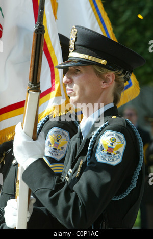 The bereaved hold their rose before placing on the National Law Enforcement Officers Memorial at the 17th Annual Wreath laying Stock Photo