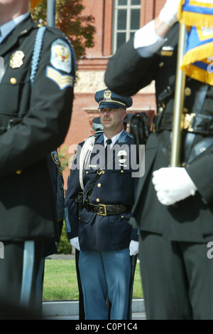 The bereaved hold their rose before placing on the National Law Enforcement Officers Memorial at the 17th Annual Wreath laying Stock Photo