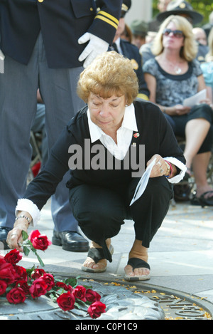 The bereaved hold their rose before placing on the National Law Enforcement Officers Memorial at the 17th Annual Wreath laying Stock Photo