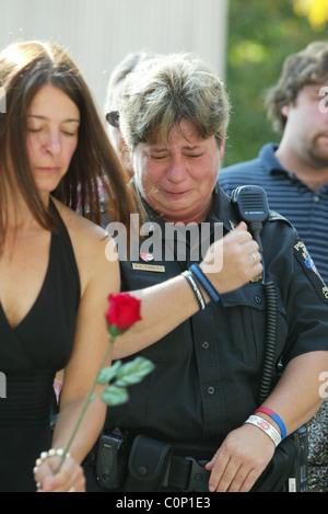 The bereaved hold their rose before placing on the National Law Enforcement Officers Memorial at the 17th Annual Wreath laying Stock Photo