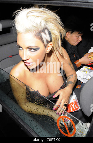 Jodie Marsh repeats her antics of a few months ago, by hanging out of her taxi while it drives around London, having spent the Stock Photo