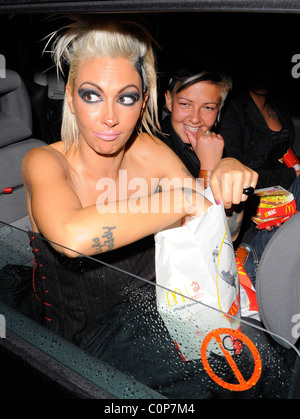 Jodie Marsh repeats her antics of a few months ago, by hanging out of her taxi while it drives around London, having spent the Stock Photo