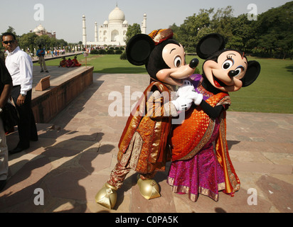 Mickey Mouse and Minnie Mouse pose at the Taj Mahal in Agra, India. The cartoon characters are in India for a special live Stock Photo