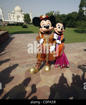 Mickey Mouse and Minnie Mouse pose at the Taj Mahal in Agra, India. The cartoon characters are in India for a special live Stock Photo