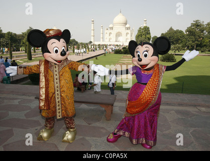 Mickey Mouse and Minnie Mouse pose at the Taj Mahal in Agra, India. The cartoon characters are in India for a special live Stock Photo