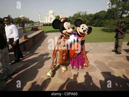 Mickey Mouse and Minnie Mouse pose at the Taj Mahal in Agra, India. The cartoon characters are in India for a special live Stock Photo