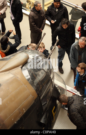 Imperial War Museum London small young child boy looking at the gun turret on a Lancaster bomber Stock Photo